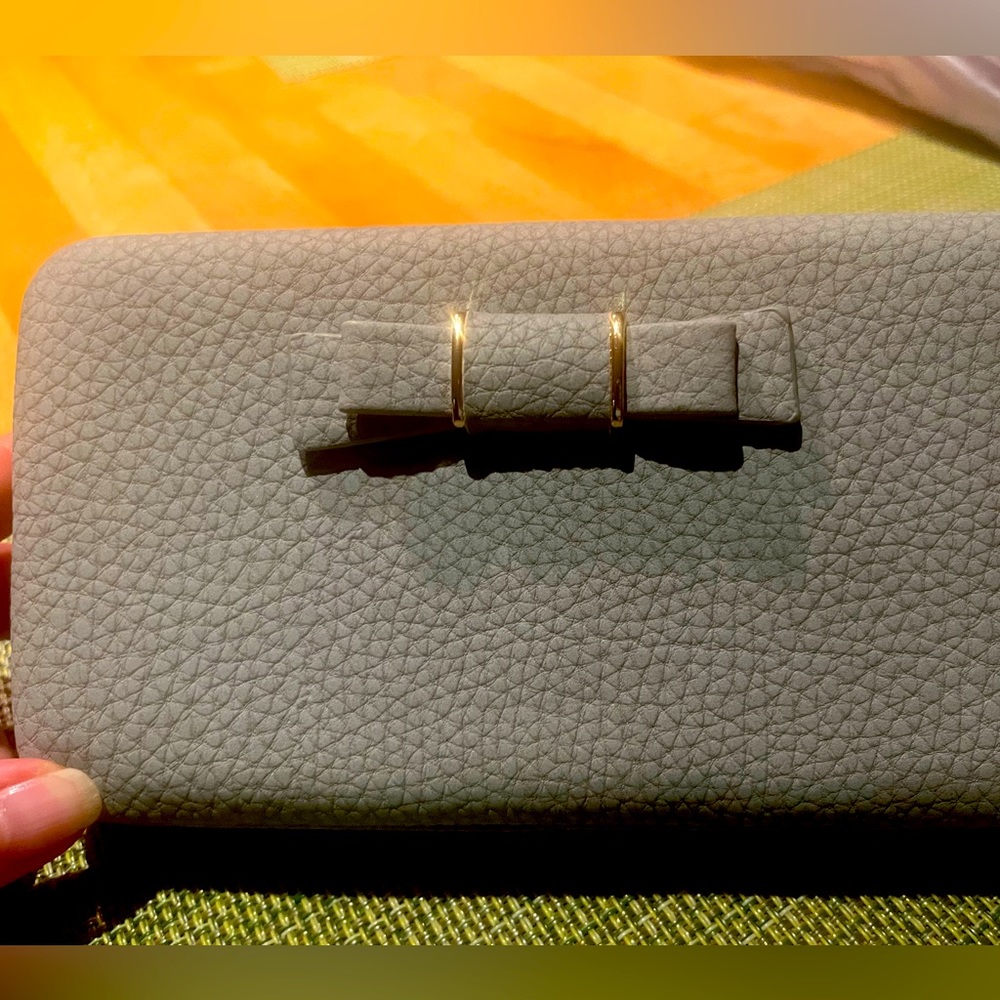 Gray pebble wallet with wristlet and clasp closure